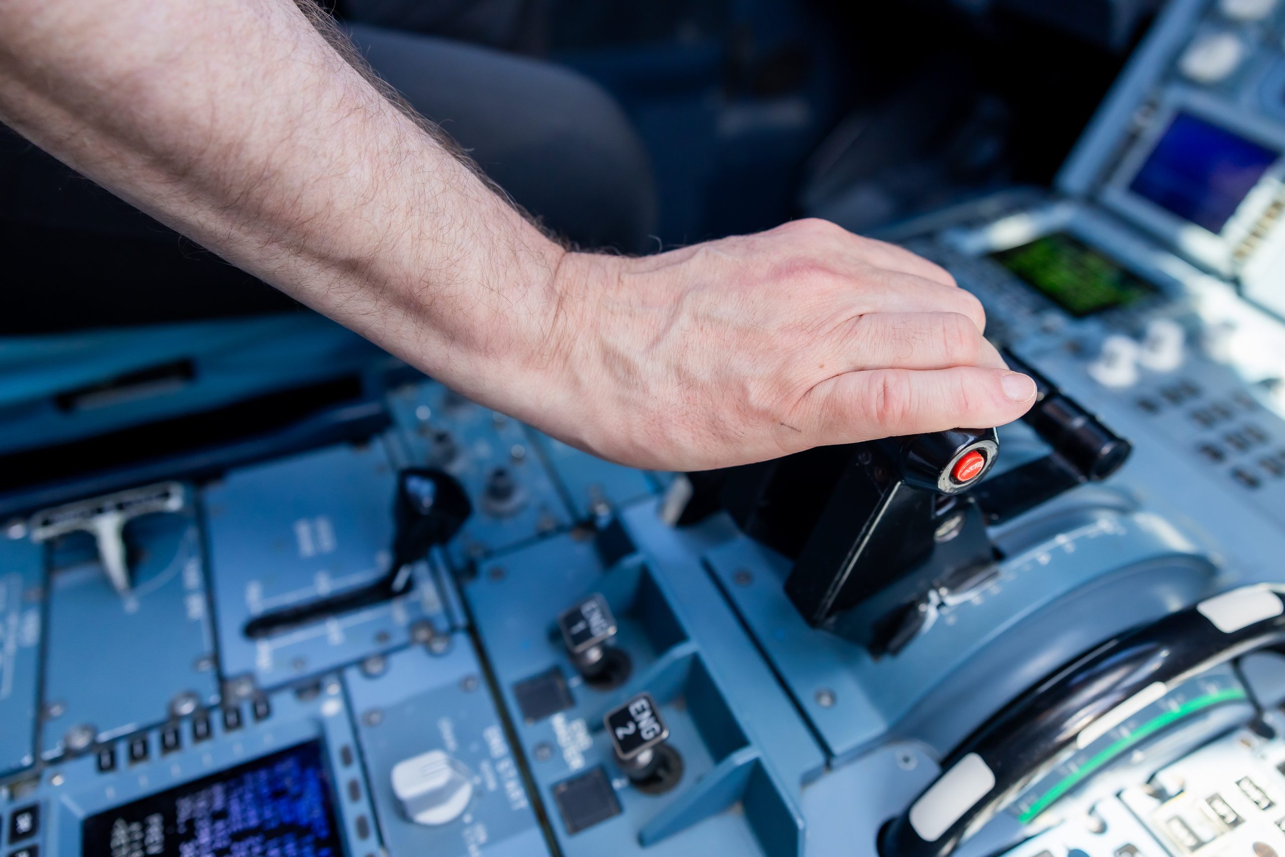 A person using the controls in an airplane cockpit