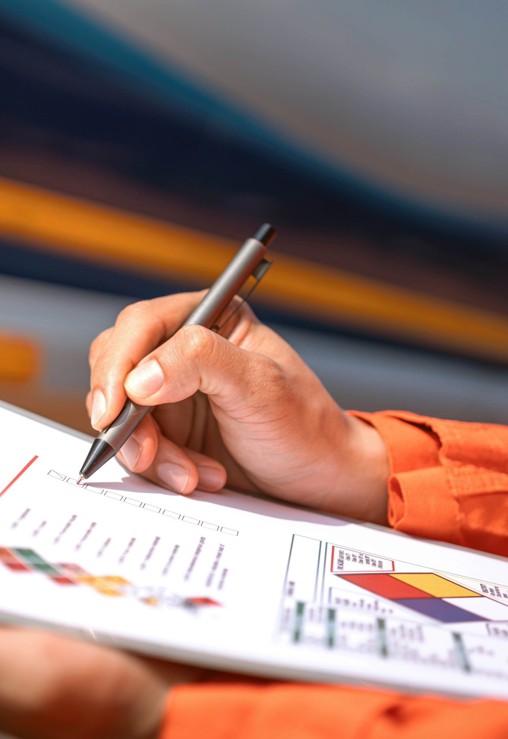 A hand making notes on a document